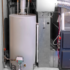 Hot water heater next to a furnace